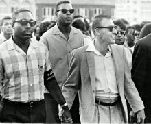 Black and White men in a march in the 1960s